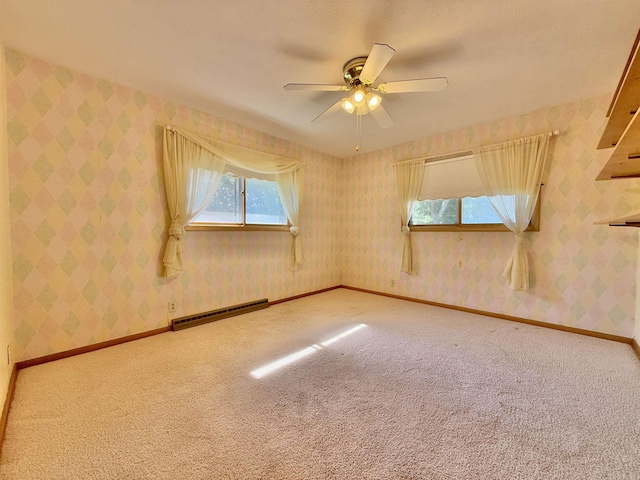 1254 N 8th St, Seward, NE 68434 - carpeted spare room featuring baseboard heating, a ceiling fan, and wallpapered walls