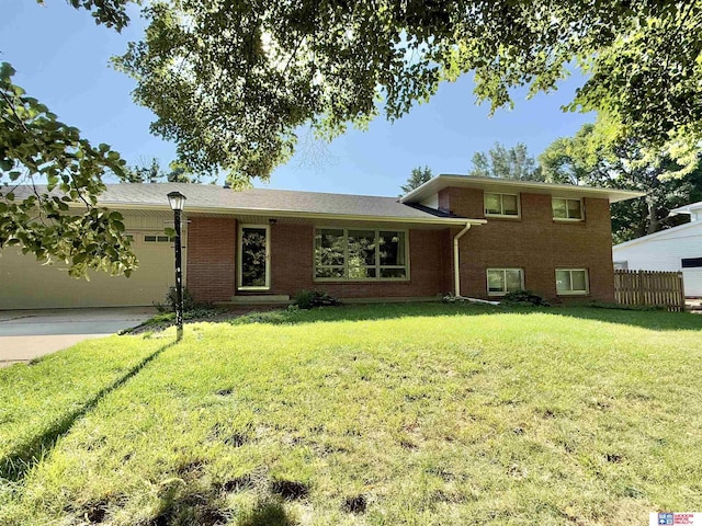 1254 N 8th St, Seward, NE 68434 - split level home with brick siding, an attached garage, and driveway