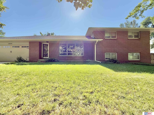 1254 N 8th St, Seward, NE 68434 - tri-level home with brick siding, a garage, and a front yard