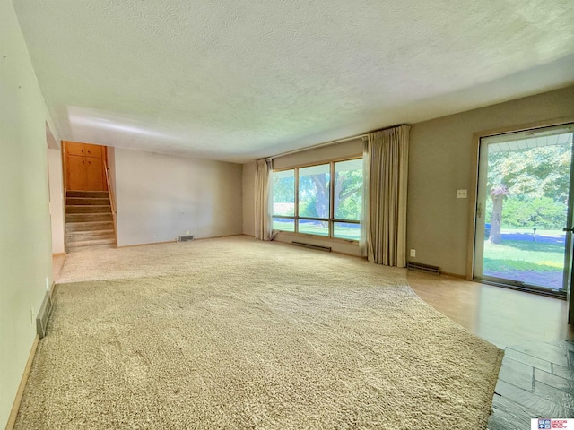 1254 N 8th St, Seward, NE 68434 - unfurnished living room with stairs and a textured ceiling