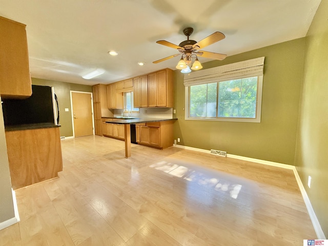1254 N 8th St, Seward, NE 68434 - kitchen with a ceiling fan, light wood-style floors, dark countertops, refrigerator, and recessed lighting