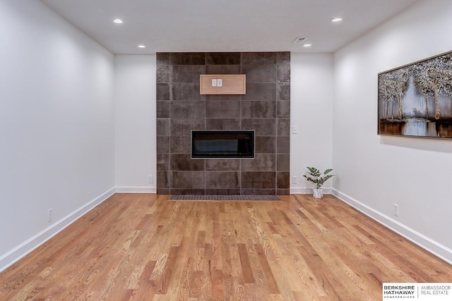 2726 N 129th Cir, Omaha, NE 68164 - unfurnished living room featuring wood finished floors, a fireplace, and recessed lighting