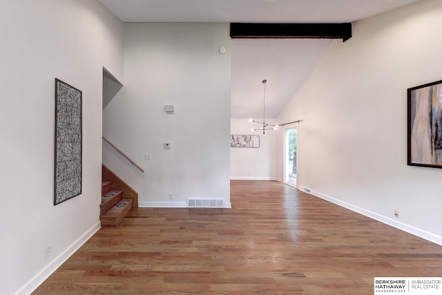 2726 N 129th Cir, Omaha, NE 68164 - unfurnished living room with high vaulted ceiling, wood finished floors, beamed ceiling, and stairway