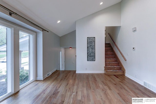 2726 N 129th Cir, Omaha, NE 68164 - unfurnished living room with high vaulted ceiling, healthy amount of natural light, wood finished floors, stairs, and recessed lighting