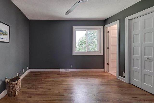 2726 N 129th Cir, Omaha, NE 68164 - unfurnished bedroom with wood finished floors, a closet, ceiling fan, and a textured ceiling
