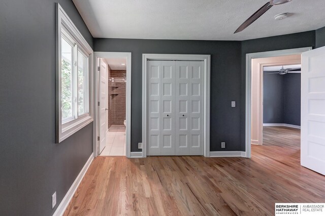 2726 N 129th Cir, Omaha, NE 68164 - unfurnished bedroom with light wood-type flooring, a closet, and ensuite bath