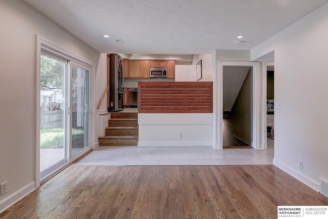 2726 N 129th Cir, Omaha, NE 68164 - unfurnished living room with light wood-style floors, stairway, and recessed lighting