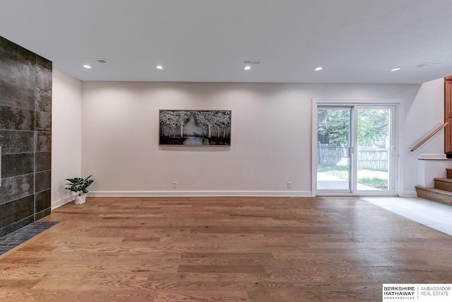2726 N 129th Cir, Omaha, NE 68164 - unfurnished living room with stairs, wood finished floors, and recessed lighting