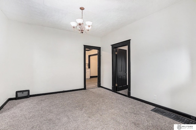 4419 N 39th St, Omaha, NE 68111 - carpeted spare room with a chandelier and a textured ceiling