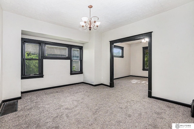 4419 N 39th St, Omaha, NE 68111 - carpeted empty room featuring plenty of natural light and a chandelier