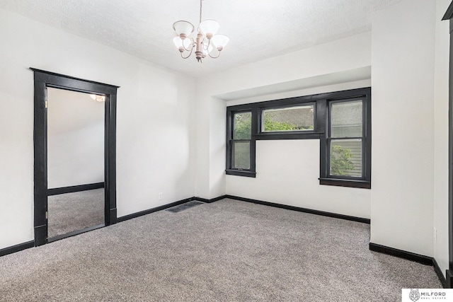 4419 N 39th St, Omaha, NE 68111 - carpeted empty room with a chandelier and a textured ceiling