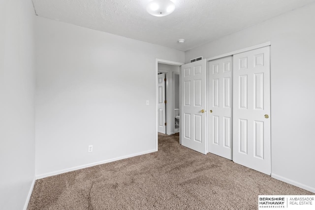 17737 Edna St, Omaha, NE 68136 - unfurnished bedroom with carpet, a textured ceiling, and a closet