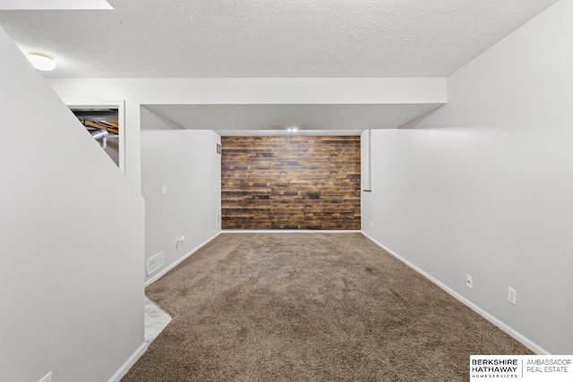 17737 Edna St, Omaha, NE 68136 - finished below grade area with carpet flooring, wooden walls, and a textured ceiling