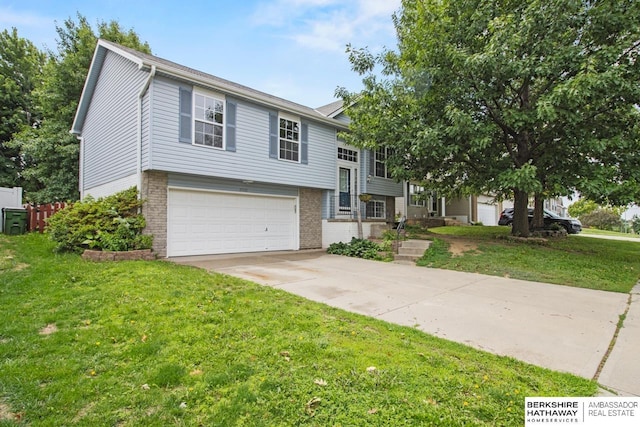 17737 Edna St, Omaha, NE 68136 - split foyer home with brick siding, a garage, driveway, and a front yard