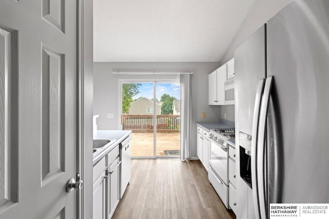 17737 Edna St, Omaha, NE 68136 - kitchen featuring white appliances, wood finished floors, white cabinets, and light countertops