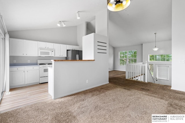 17737 Edna St, Omaha, NE 68136 - kitchen with white appliances, track lighting, white cabinets, high vaulted ceiling, and light carpet