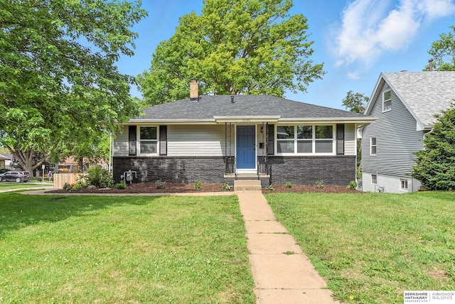 3080 S 48th St, Omaha, NE 68106 - view of front facade with a front yard and a chimney