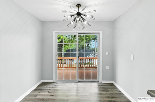 3080 S 48th St, Omaha, NE 68106 - unfurnished dining area with a chandelier and wood finished floors
