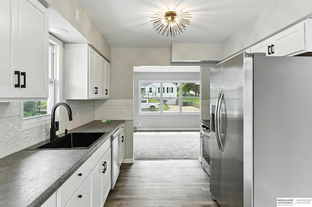 3080 S 48th St, Omaha, NE 68106 - kitchen featuring stainless steel appliances, dark countertops, dark wood-style floors, and healthy amount of natural light