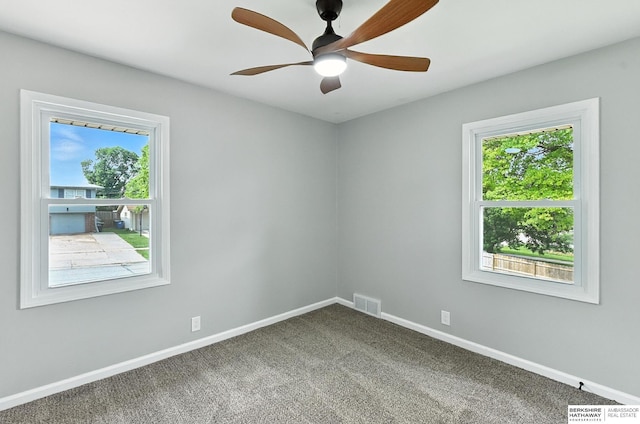3080 S 48th St, Omaha, NE 68106 - empty room featuring carpet floors, plenty of natural light, and ceiling fan