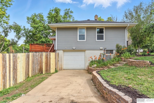 3080 S 48th St, Omaha, NE 68106 - view of side of home featuring a chimney, a garage, and driveway