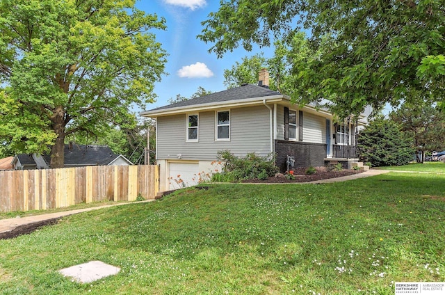 3080 S 48th St, Omaha, NE 68106 - view of home's exterior with a garage and a chimney