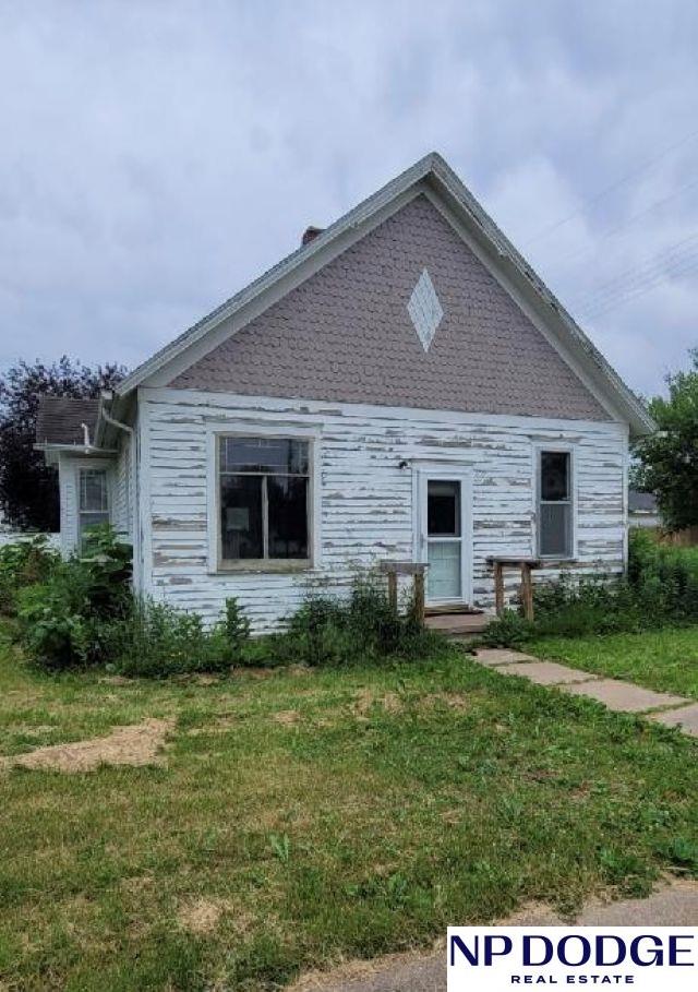 609 Howard St, Scribner, NE 68057 - view of property exterior with a lawn
