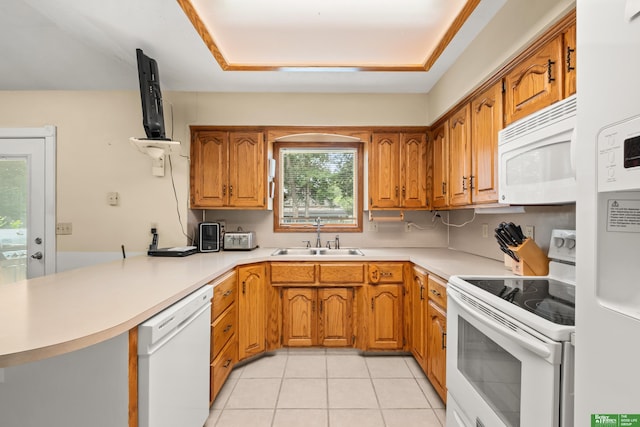 411 Hillside Ave, Yutan, NE 68073 - kitchen featuring white appliances, brown cabinetry, light countertops, and a peninsula