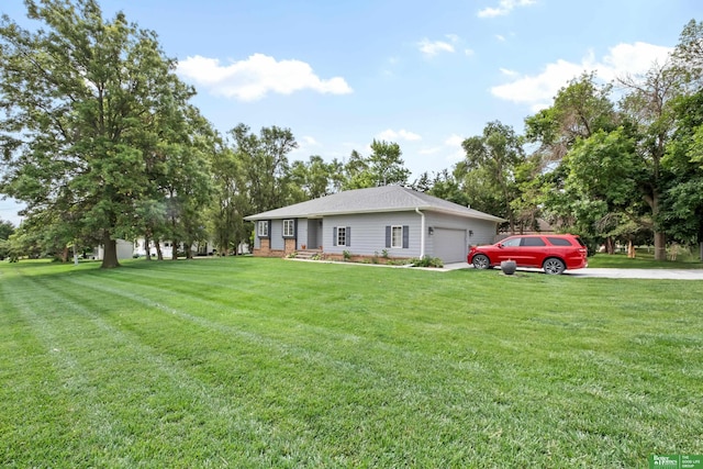 411 Hillside Ave, Yutan, NE 68073 - view of front of home featuring an attached garage, a front yard, and driveway