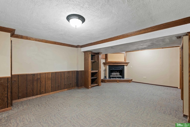 36 Redwood Ln, Yutan, NE 68073 - finished basement featuring crown molding, a fireplace with raised hearth, a wainscoted wall, a textured ceiling, and carpet floors