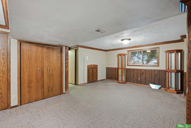 36 Redwood Ln, Yutan, NE 68073 - basement featuring a textured ceiling, carpet flooring, crown molding, wainscoting, and wooden walls