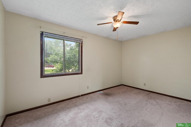 36 Redwood Ln, Yutan, NE 68073 - spare room with carpet flooring, a ceiling fan, and a textured ceiling