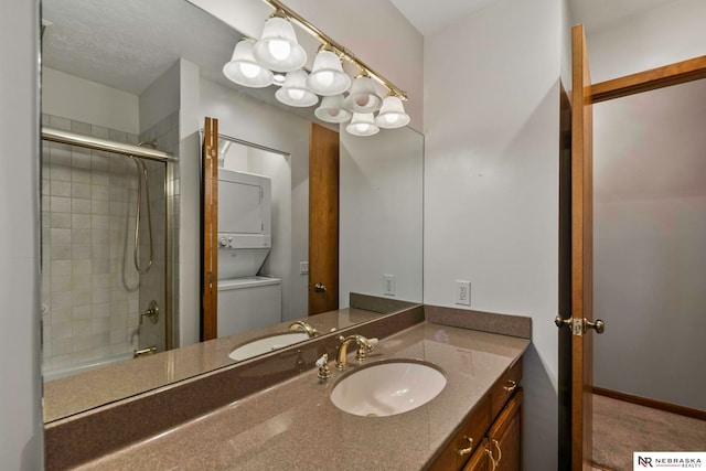 11018 Hascall St, Omaha, NE 68144 - full bath featuring stacked washing machine and dryer, vanity, and bath / shower combo with glass door