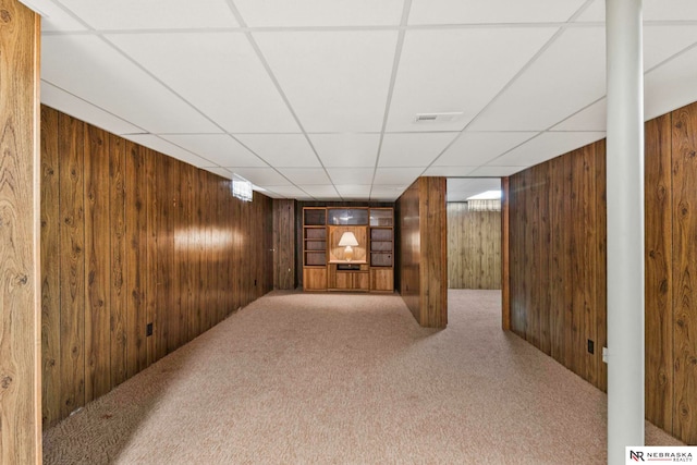 11018 Hascall St, Omaha, NE 68144 - hall with wood walls, carpet flooring, and a paneled ceiling