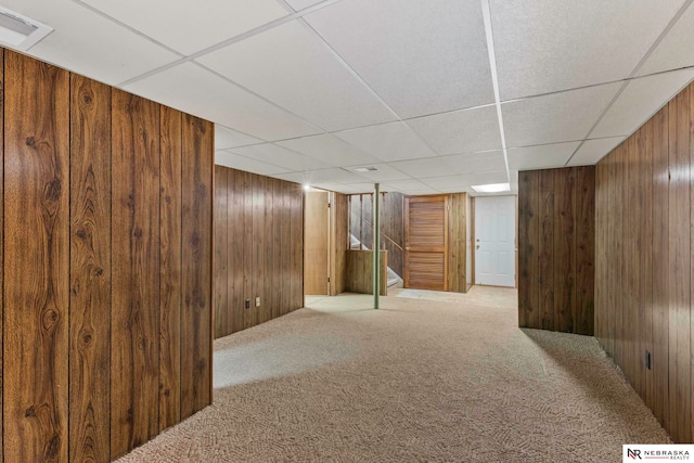 11018 Hascall St, Omaha, NE 68144 - finished basement with wood walls, carpet floors, a paneled ceiling, and stairway