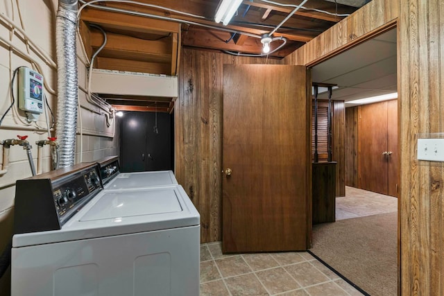 11018 Hascall St, Omaha, NE 68144 - laundry area featuring washing machine and clothes dryer and wood walls