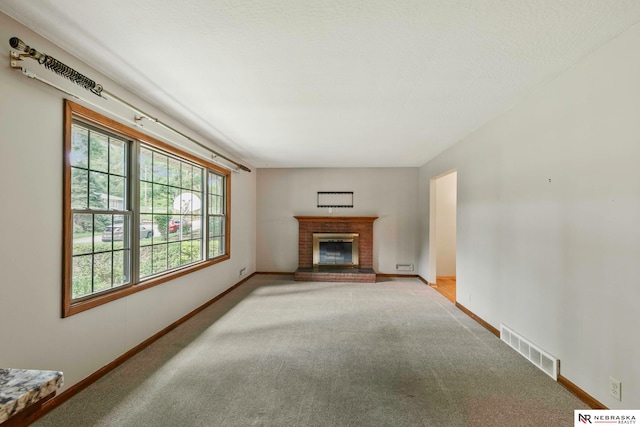 11018 Hascall St, Omaha, NE 68144 - unfurnished living room featuring light colored carpet and a brick fireplace