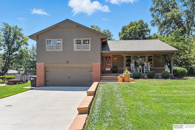 9903 Pasadena Ave, Omaha, NE 68124 - tri-level home with a porch, brick siding, a front yard, an attached garage, and driveway