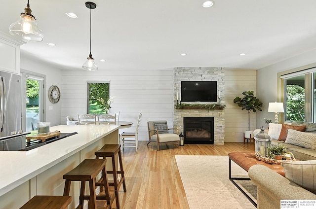 9903 Pasadena Ave, Omaha, NE 68124 - living area featuring healthy amount of natural light, a fireplace, light wood-style floors, and recessed lighting