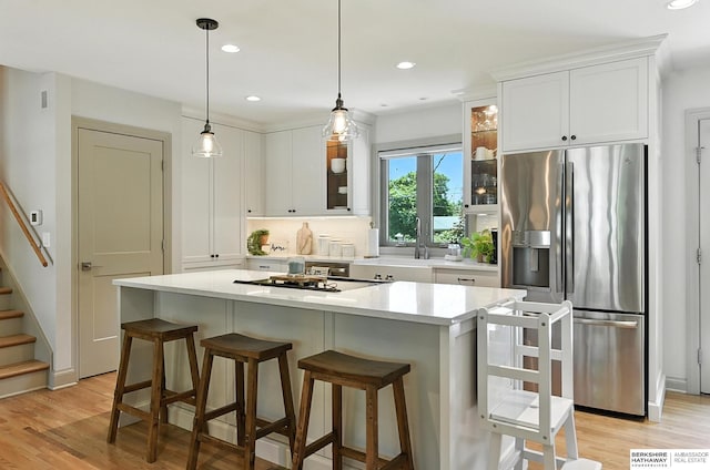 9903 Pasadena Ave, Omaha, NE 68124 - kitchen with stainless steel fridge with ice dispenser, light wood-style flooring, white cabinetry, glass insert cabinets, and recessed lighting