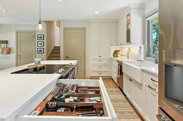 9903 Pasadena Ave, Omaha, NE 68124 - kitchen featuring stainless steel appliances, light countertops, white cabinets, glass insert cabinets, and recessed lighting
