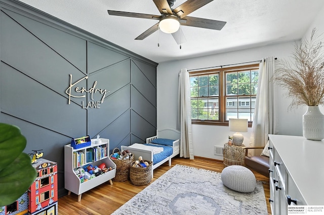 9903 Pasadena Ave, Omaha, NE 68124 - rec room featuring wood finished floors, a ceiling fan, and a chandelier