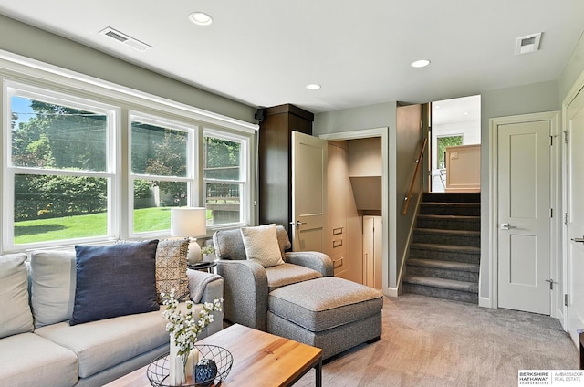 9903 Pasadena Ave, Omaha, NE 68124 - living room featuring light colored carpet, stairway, and recessed lighting
