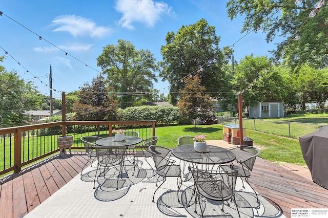 9903 Pasadena Ave, Omaha, NE 68124 - wooden terrace featuring outdoor dining area and a shed