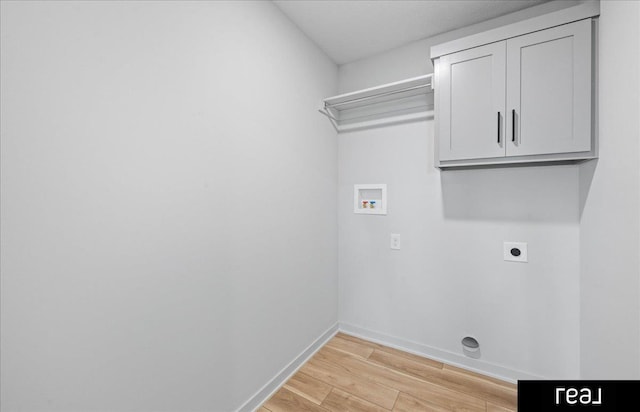 7409 N 176th Ave, Bennington, NE 68007 - washroom featuring hookup for an electric dryer, hookup for a washing machine, light wood-type flooring, and cabinet space