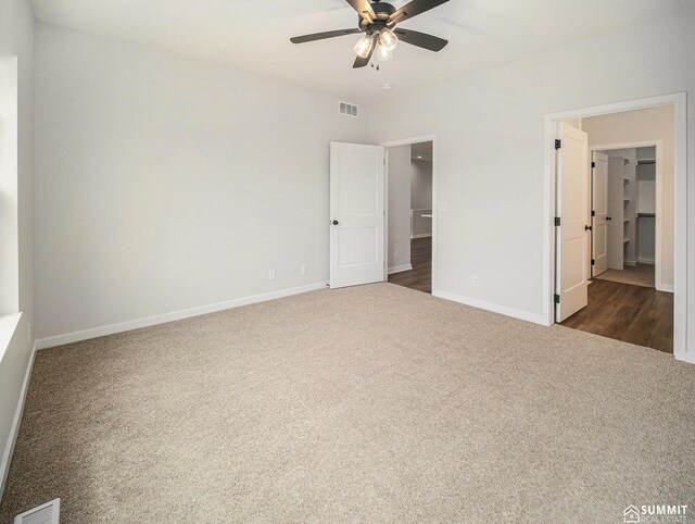 1070 Titan Dr, Hickman, NE 68372 - unfurnished bedroom with dark colored carpet and ceiling fan