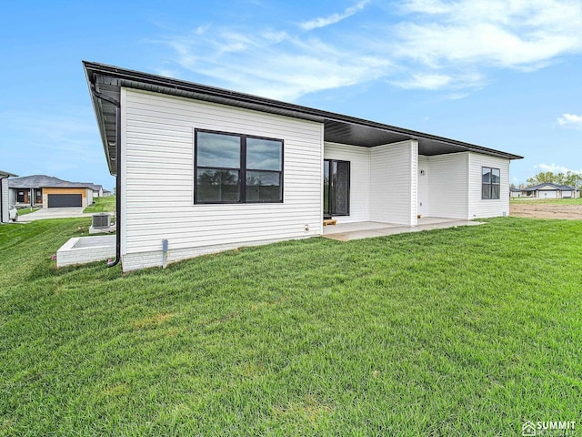 1120 Titan Dr, Hickman, NE 68372 - rear view of property with a lawn and a patio area