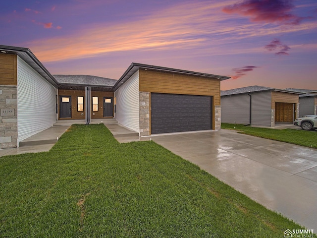 1120 Titan Dr, Hickman, NE 68372 - view of front facade featuring a front lawn, a garage, driveway, and stone siding