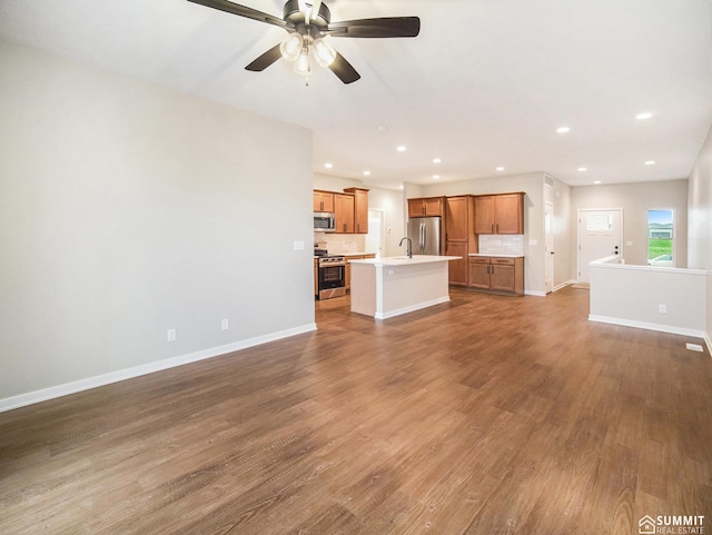 1120 Titan Dr, Hickman, NE 68372 - unfurnished living room with wood finished floors, a ceiling fan, and recessed lighting