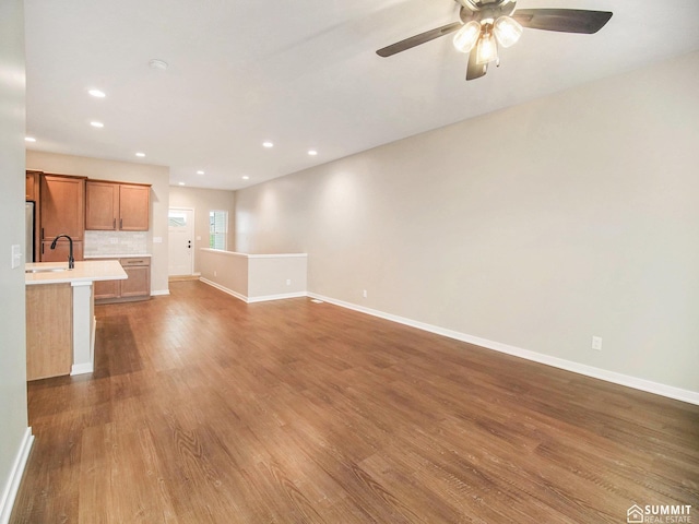 1120 Titan Dr, Hickman, NE 68372 - unfurnished living room featuring wood finished floors, a ceiling fan, and recessed lighting
